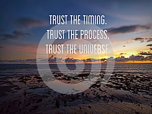 Inspirational motivational quote - Trust the timing. Trust the process. Trust the universe. On beach background at sunrise.