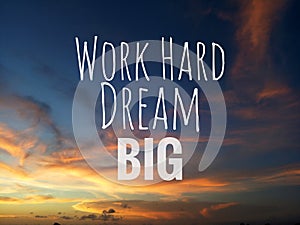 Inspirational motivational quote - Work hard, dream big. With blurry background of dramatic and colorful sky clouds view. photo