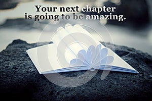 Inspirational motivational quote - Your next chapter is going to be amazing. With open book and white paper pages flower shape.