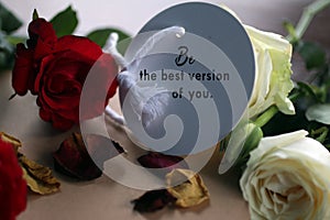 Inspirational motivational text message - Be the best version of you. Note to self concept on paper tag label with red white roses