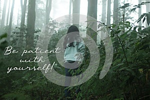 Inspirational motivational words - Be patient with yourself. With young girl walking alone in the misty forest.