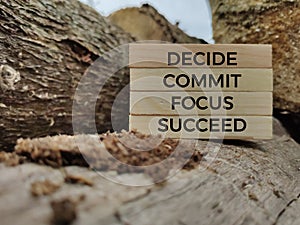 Inspirational and motivational words of decide commit focus succeed on wooden blocks