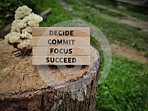 Inspirational and motivational words of decide commit focus succeed on wooden blocks