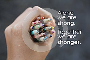 Inspirational quote - Alone we are strong. Together we are stronger. With Bunch of colored pencils in hand