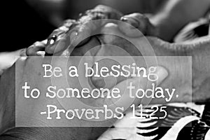 Inspirational quote - Be a blessing to someone today. Proverbs 11.25. On artistic background of women holding hands on lap.