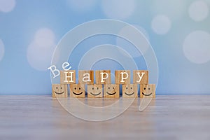 Inspirational quote - Be happy. With happy face emotion graphic arranged in stair shape. Happiness motivational words with smiles.