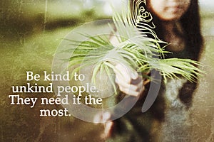 Inspirational quote - Be kind to unkind people. They need it the most. With young woman holding fern plant or palm leaves in hand. photo