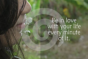 Inspirational quote - Be in love with your life every minute of it. Self love and care concept with a girl kiss a grass flower.