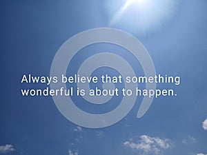 Inspirational quote - Always believe that something wonderful is about to happen. With bright & blue sky background.