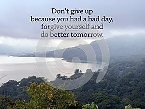 Inspirational quote - Don`t give up because you had a bad day, forgive yourself and do better tomorrow. On blue blue nature lake. photo