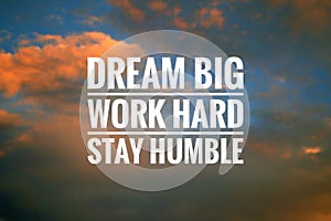 Inspirational quote - Dream big. Work hard. Stay humble. Sign and text message on dramatic colorful sky background.