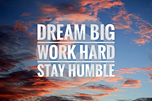 Inspirational quote - Dream big. Work hard. Stay humble. Sign and text message on dramatic colorful sky background.