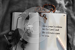 Inspirational quote - Give your burdens to the Lord and He will take care of you . With Wooden Rosary, a pen and notebook. photo
