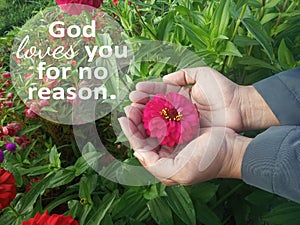 Inspirational quote - God loves you for no reason. With person holding a red flower. Spirituality believe in God concept photo