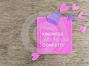 Inspirational Quote Good Vibes Concept - Throw kindness around like confetti text on note paper with hearts background.