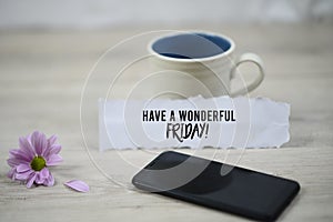 Inspirational quote - Have a wonderful Friday. With a cup of Friday morning coffee, purple daisy flower and a black cellphone.