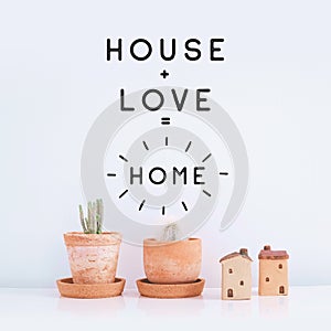 Inspirational quote `House,Love,Home`. Cactus plant on white background.