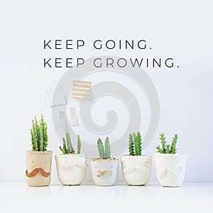 Inspirational quote `Keep going, Keep growing`. Cactus plant on white background.