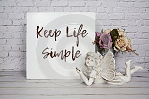 Inspirational quote Keep Life Simple text message written on white wooden board