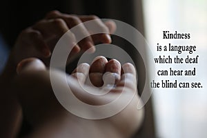 Inspirational quote - Kindness is a language which the deaf can hear and the blind can see. With two helping hands reaching out.