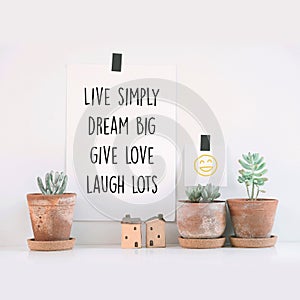 Inspirational quote `Live simply, dream big, give love, laugh lots`.