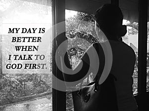 Inspirational quote - My day is better when i talk to God first. Spiritual message sigh on window with young woman standing alone photo