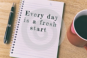 Inspirational quote on notepad - Every day is a fresh start