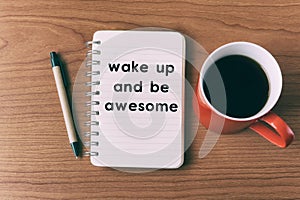 Inspirational quote on notepad - wake up and be awesome
