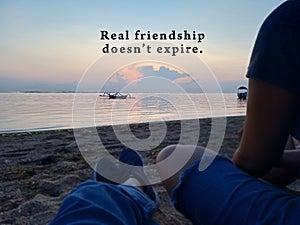 Inspirational quote - Real friendship does not expire. With two best friends of young women sitting enjoying the beach view.