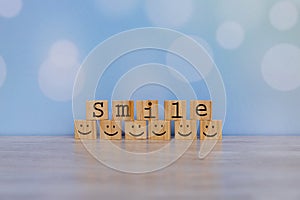 Inspirational quote - Smile. With happy face emotion graphic arranged in stair shape. Positive attitude, customer satisfaction,