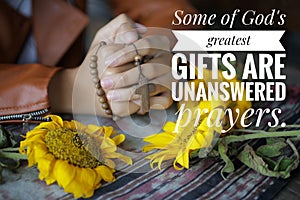 Inspirational quote - Some of God greatest gifts are unanswered prayer. With young junior woman in a prayer pose. With Rosary.