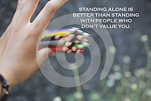 Inspirational quote - Standing alone is bettern than standing with people who do not value you. With motion bunch of pencils color