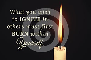 Inspirational quote text - What you wish to ignite in others must first burn within yourself. With candle on dark