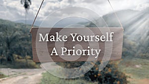 Inspirational quote text on wooden banner - Make yourself a priority. Inspirational concept