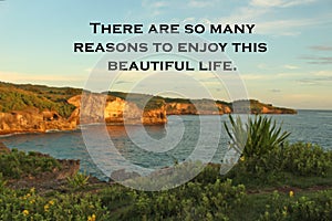 Inspirational quote - There are so many reasons to enjoy this beautiful life.  On blurry background of  sunset light on the cliff photo