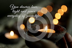 Inspirational quote - You deserve love, light, peace everyday of your life. Self love care worthy concept with candle in hand.
