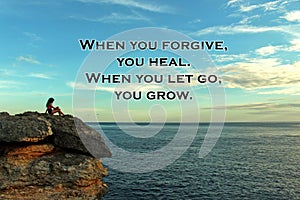 Inspirational quote - When you forgive, you heal. When you let go, you grow. On blurry background of bright blue sky over horizon.