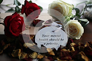 Inspirational quote - Your mental health should be a priority. Self care concept with motivational text message on paper tag label