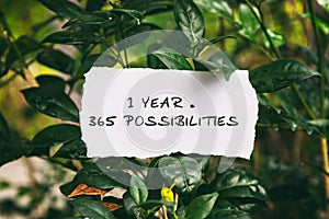 Inspirational quotes - 1 year = 365 possibilities. Blurry background