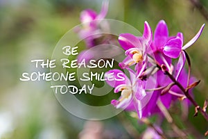 Inspirational quotes - Be the reason someone smiles today. Blurry background