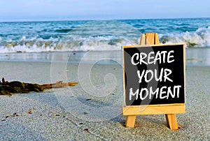 Inspirational quotes on black board - Create your Moment.