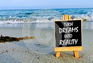 Inspirational quotes on black board - Turn Dreams Into Reality.