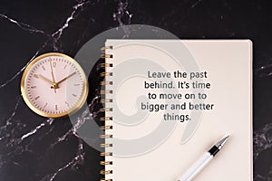 Inspirational quotes on notepad - Leave the past behind. It\'s time to move on to bigger and better things