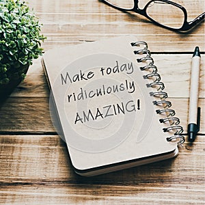 Inspirational quotes on a notepad - Make today ridiculously amazing. Blurry retro style background