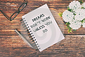 Inspirational Quotes text on notepad - Dreams don`t work unless you do