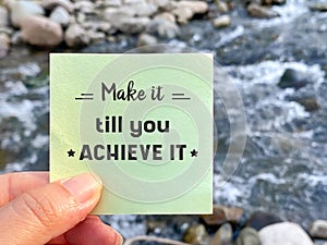 Inspirational Success Quote - make it till you achieve it on paper with nature background. Stock photo.