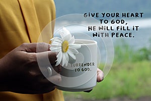 Inspirational words - Give your heart to God, He will fill it with peace. Surrender to God concept with text notes on a coffee cup