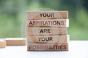 Inspirational words on wooden blocks - Your aspirations are you possibilities. Inspirational and motivational concept