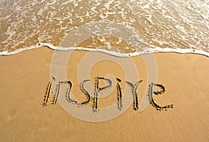 Inspire drawn on the beach photo