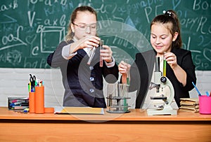 Inspire. Little girls scientist with microscope. Biology lab. Happy Genius. Little girls genius in school lab. Science